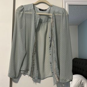 Zara Woman light sheer blouse with gold skull buttons.